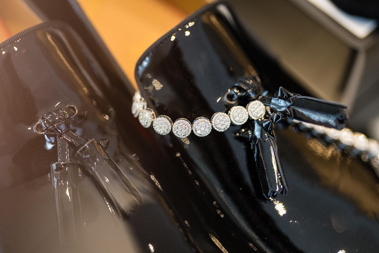 Diamond bracelet on patent leather groom shoes
