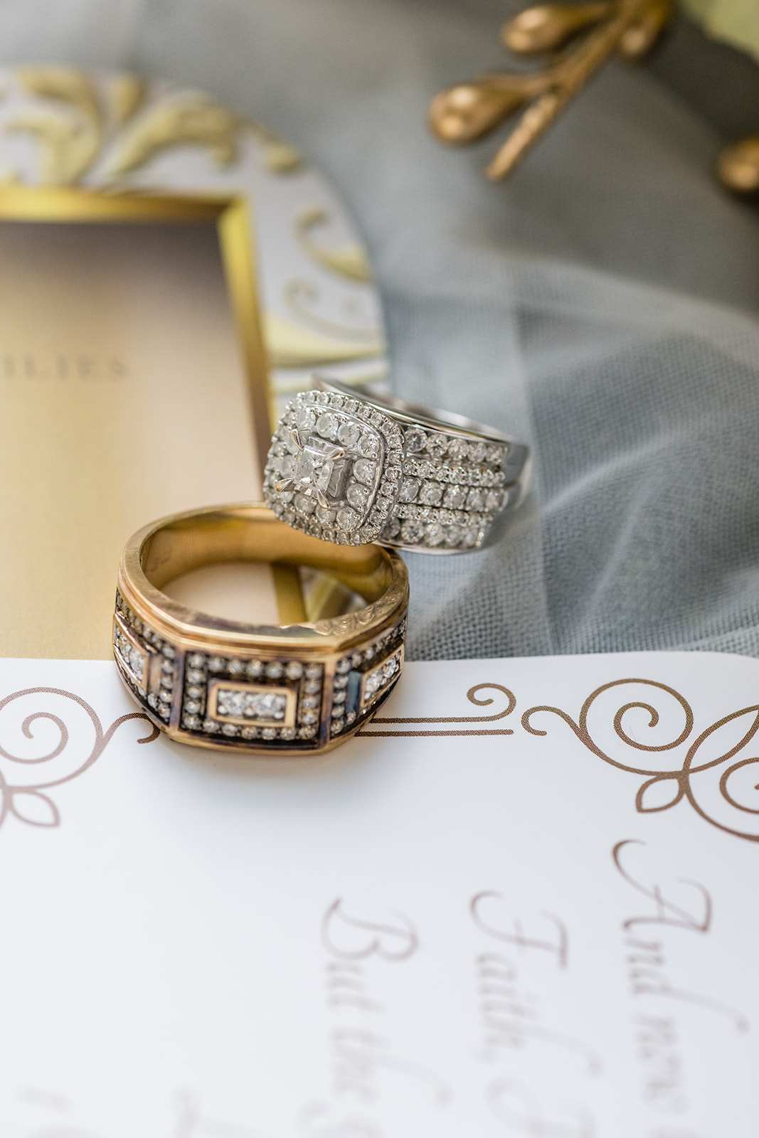 His and hers rings with gold band on invitation flatlay