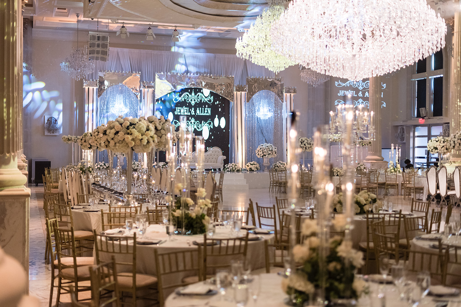 Luxury reception hall with chandeliers and white florals