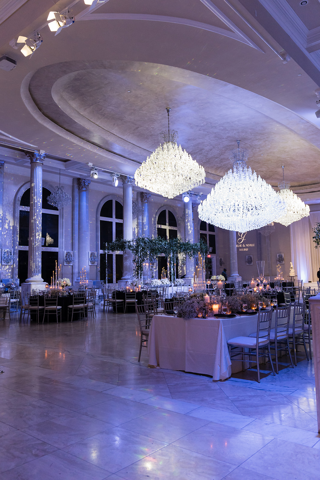 Reception hall with crystal chandeliers and candlelit tables