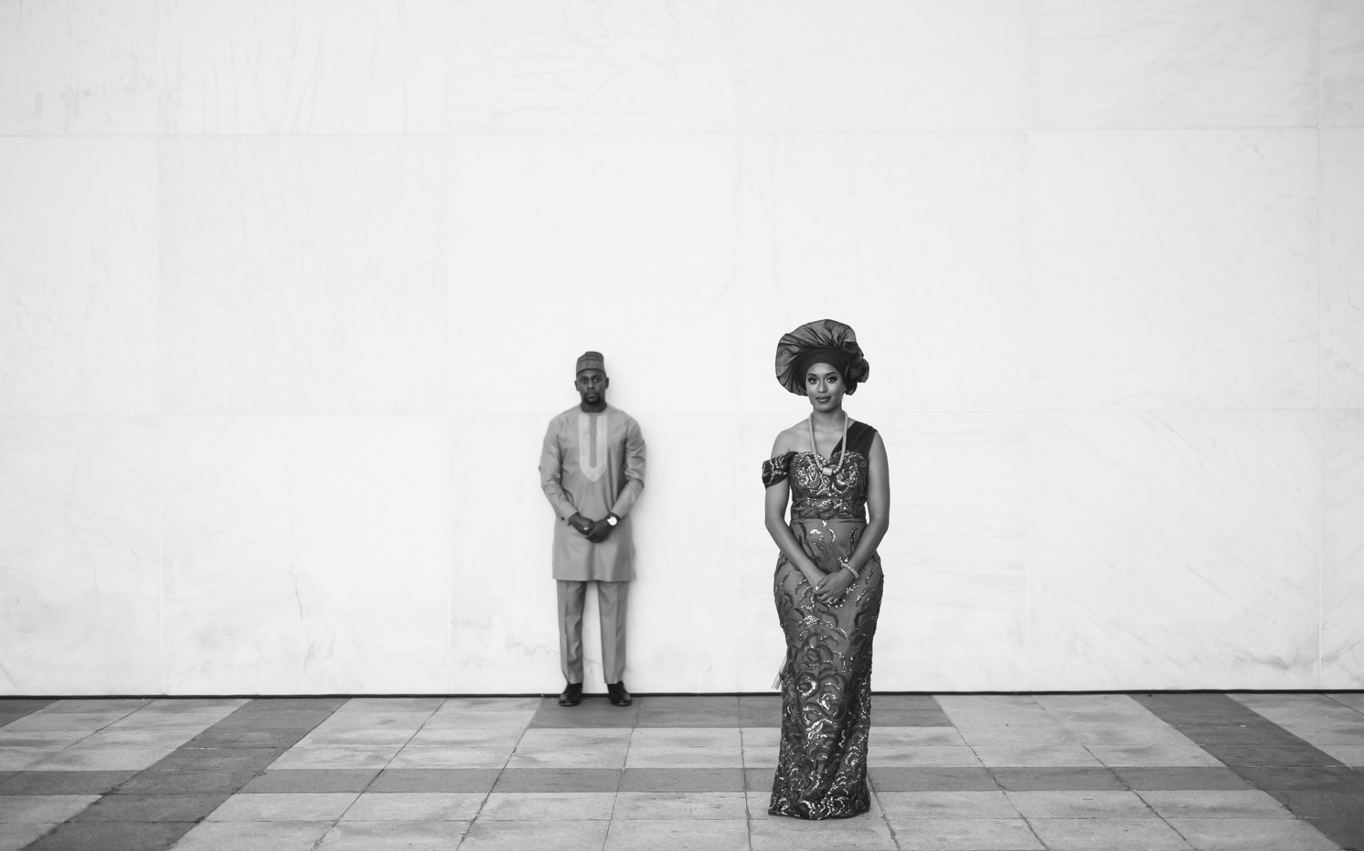 Couple in traditional attire marble wall black and white editorial