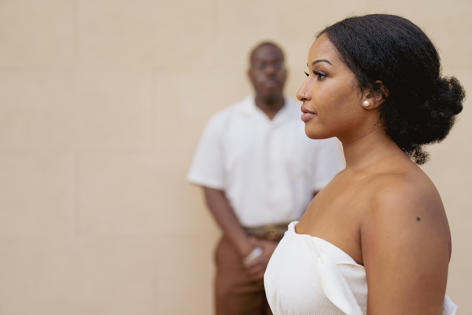 Woman profile with updo and pearl earring closeup