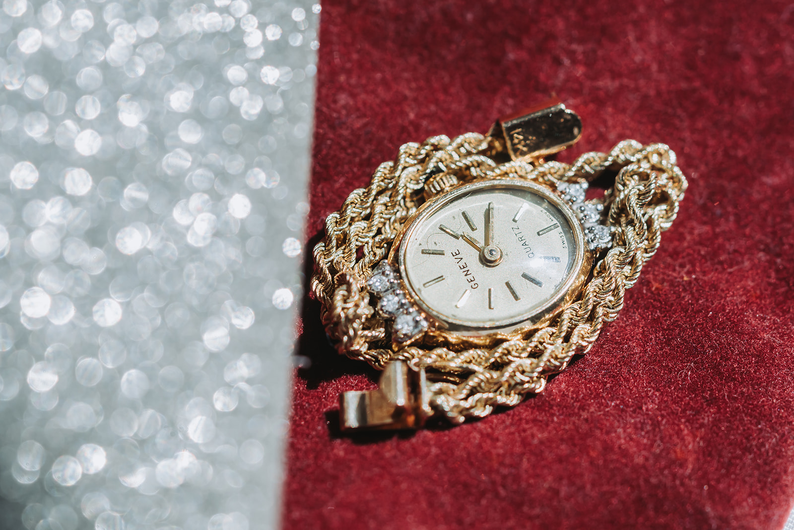 Vintage gold Geneve watch with diamonds on red velvet macro