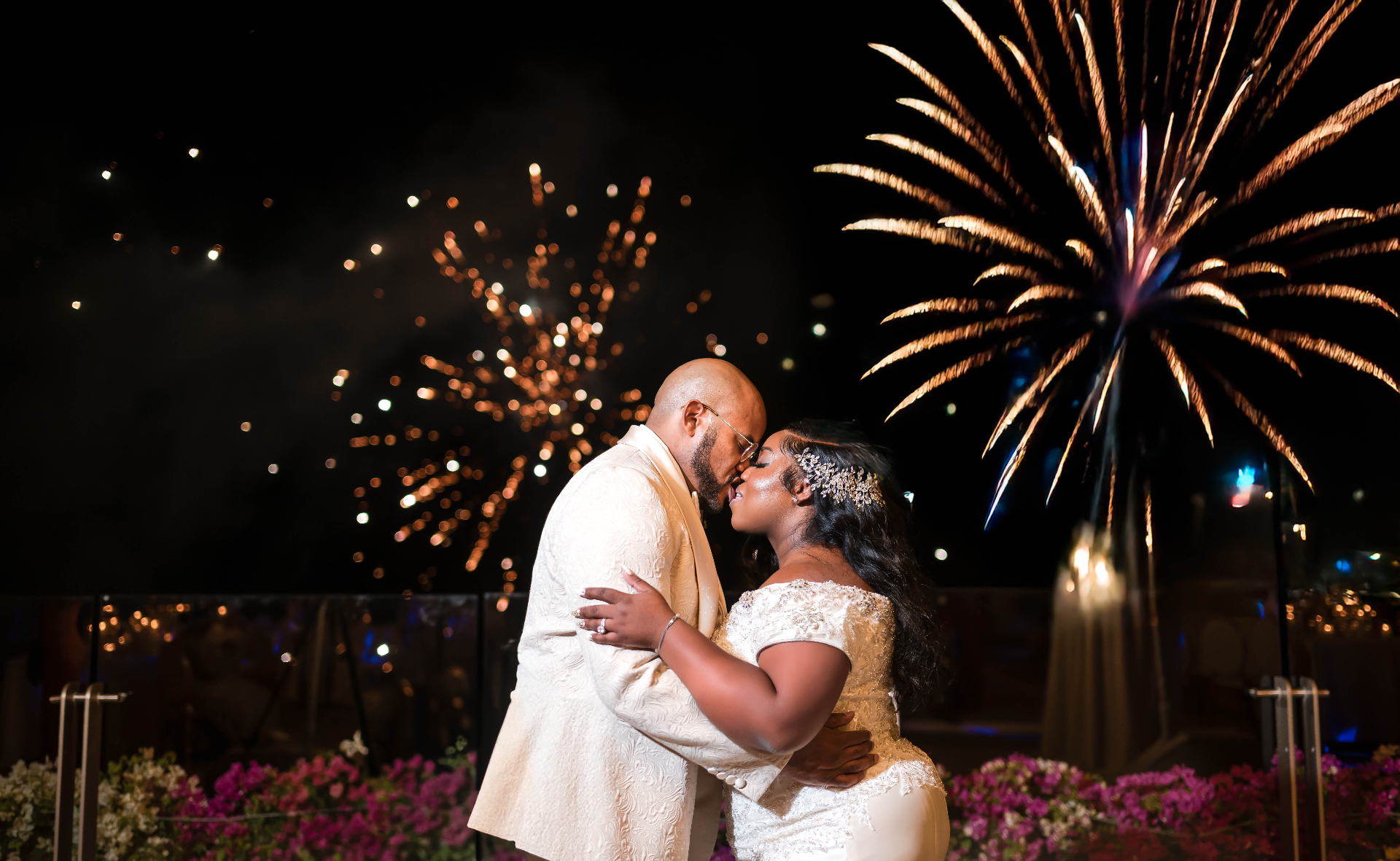 Couple kiss under fireworks at night Los Cabos destination wedding