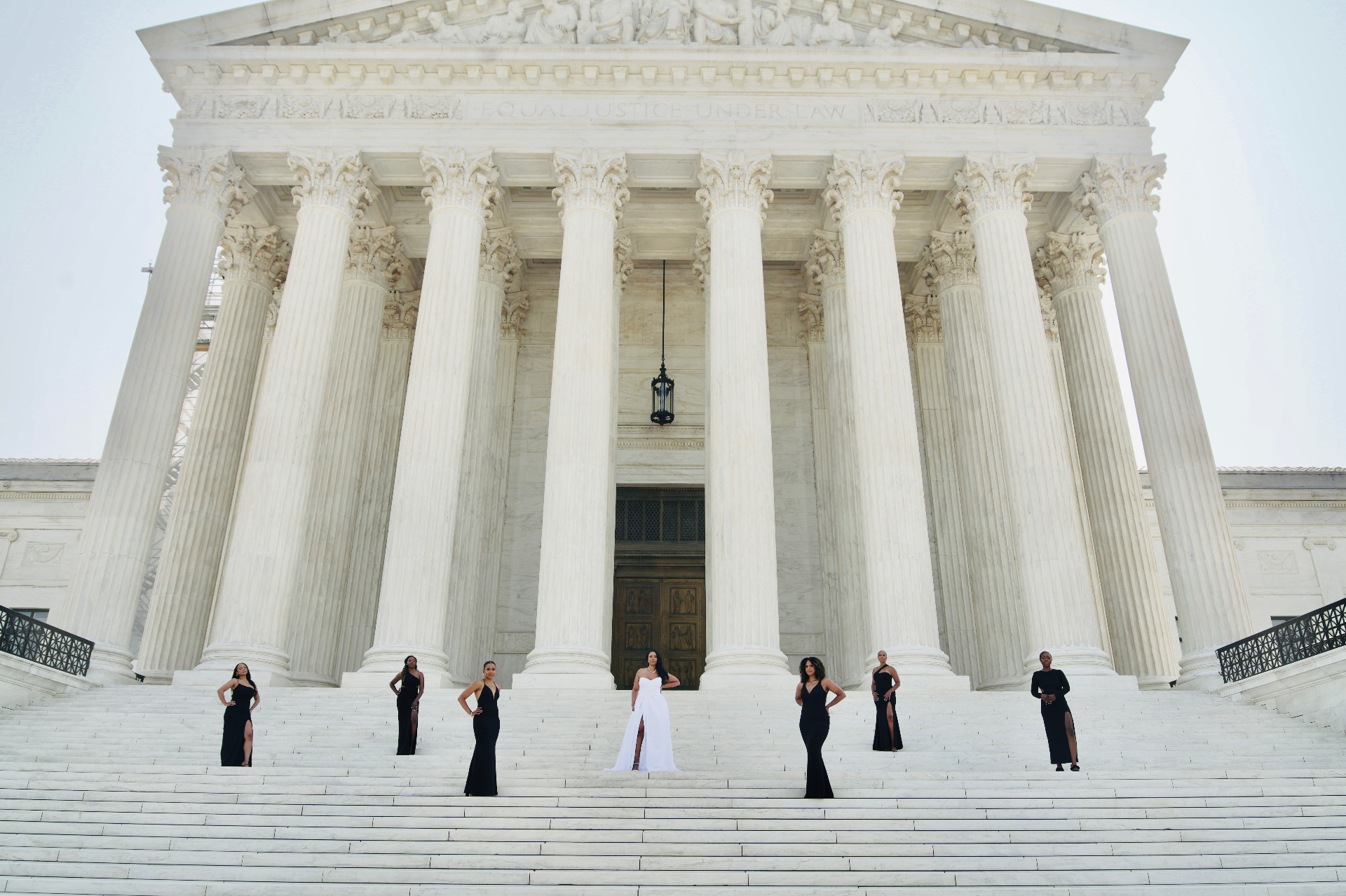 Bridal party on Supreme Court steps in black and white gowns