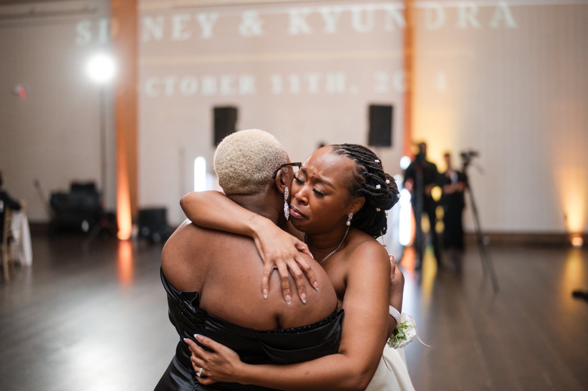 Bride emotional hug with mother during reception dance