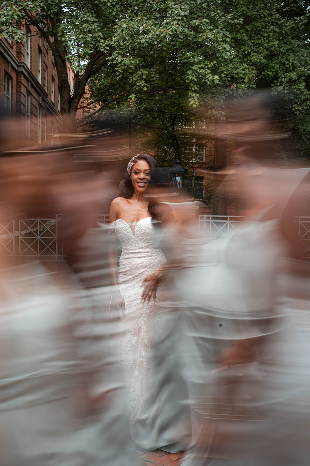 Bride sharp with motion blur bridesmaids brick courtyard creative