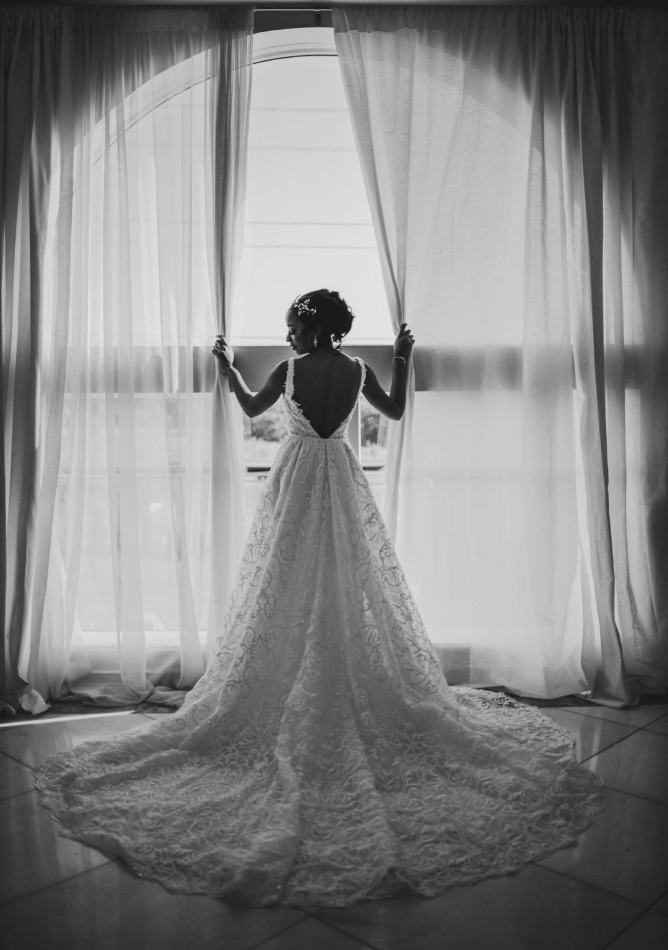 Bride silhouette opening curtains lace gown black and white