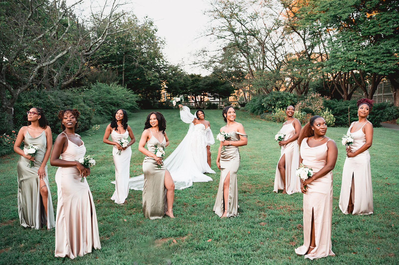 Bridesmaids in champagne satin gowns garden bridal party