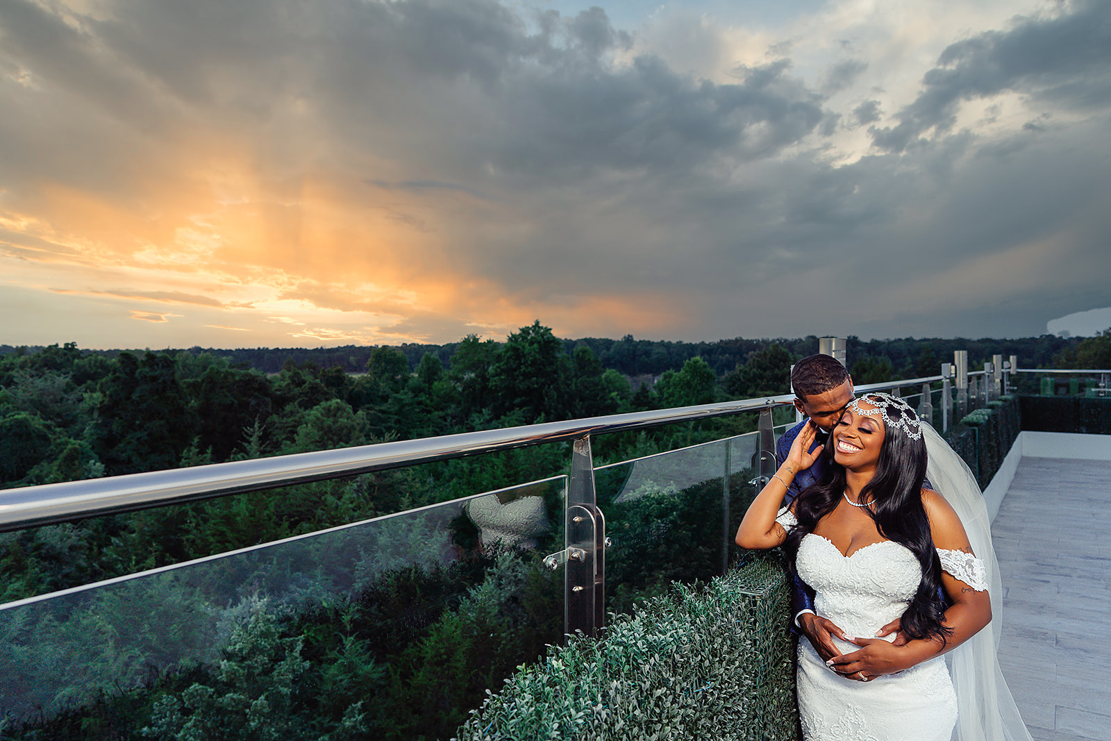 Couple portrait with dramatic rooftop sunset sky