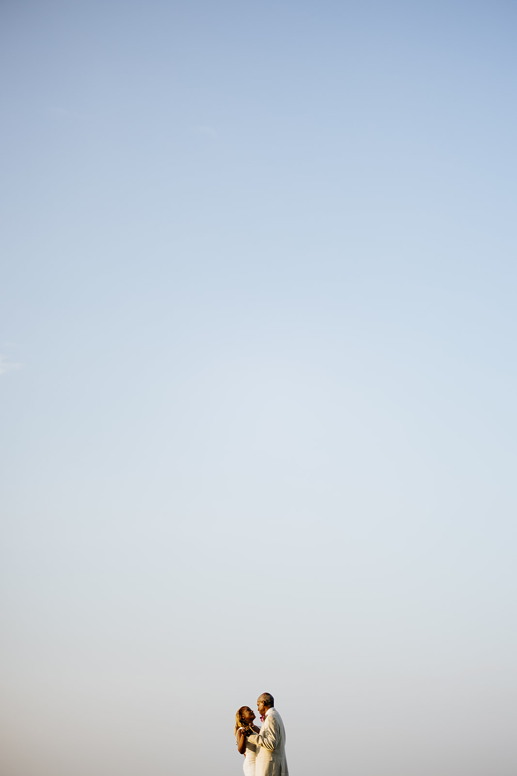 Couple portrait against sunset sky