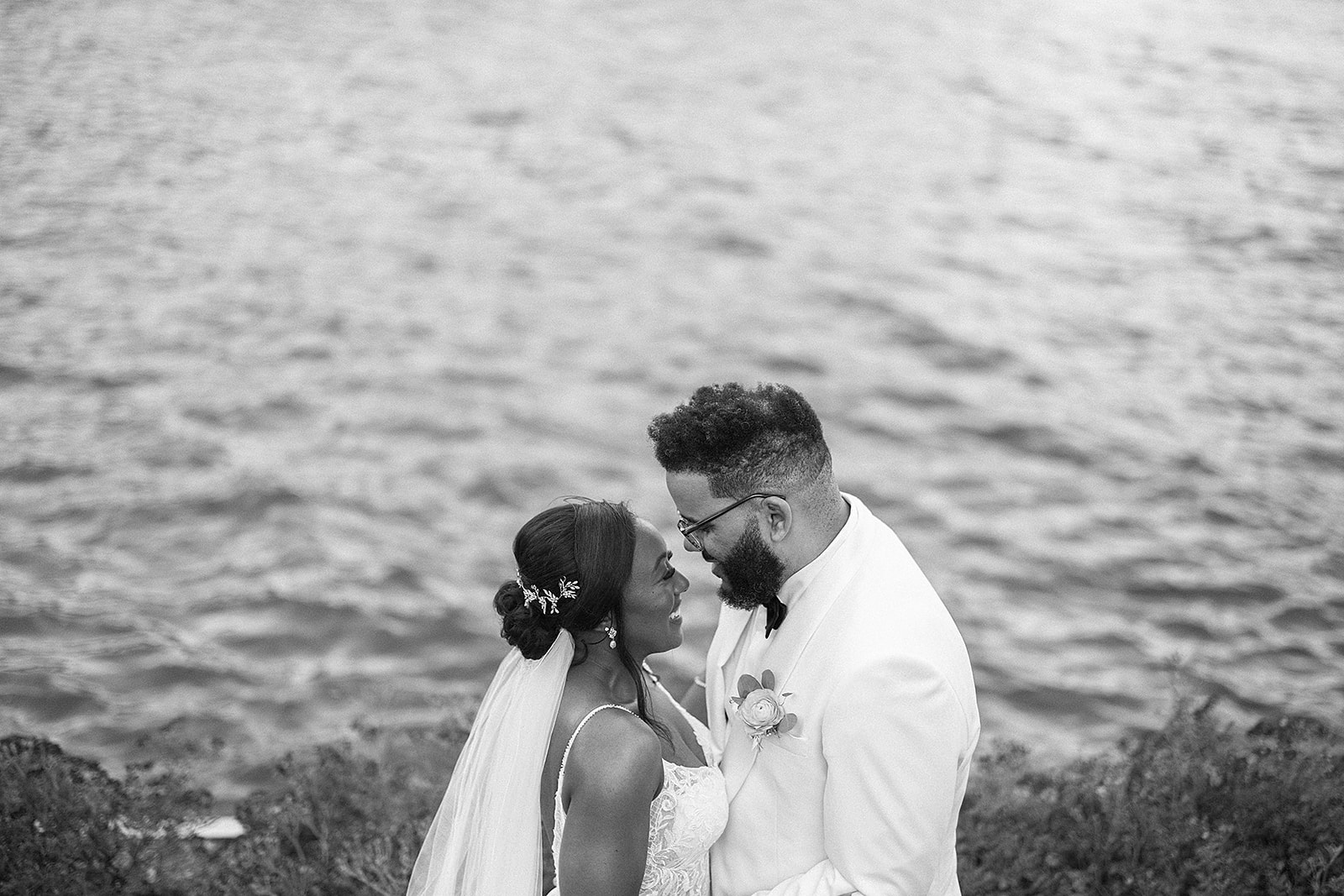 Couple intimate moment at waterfront black and white