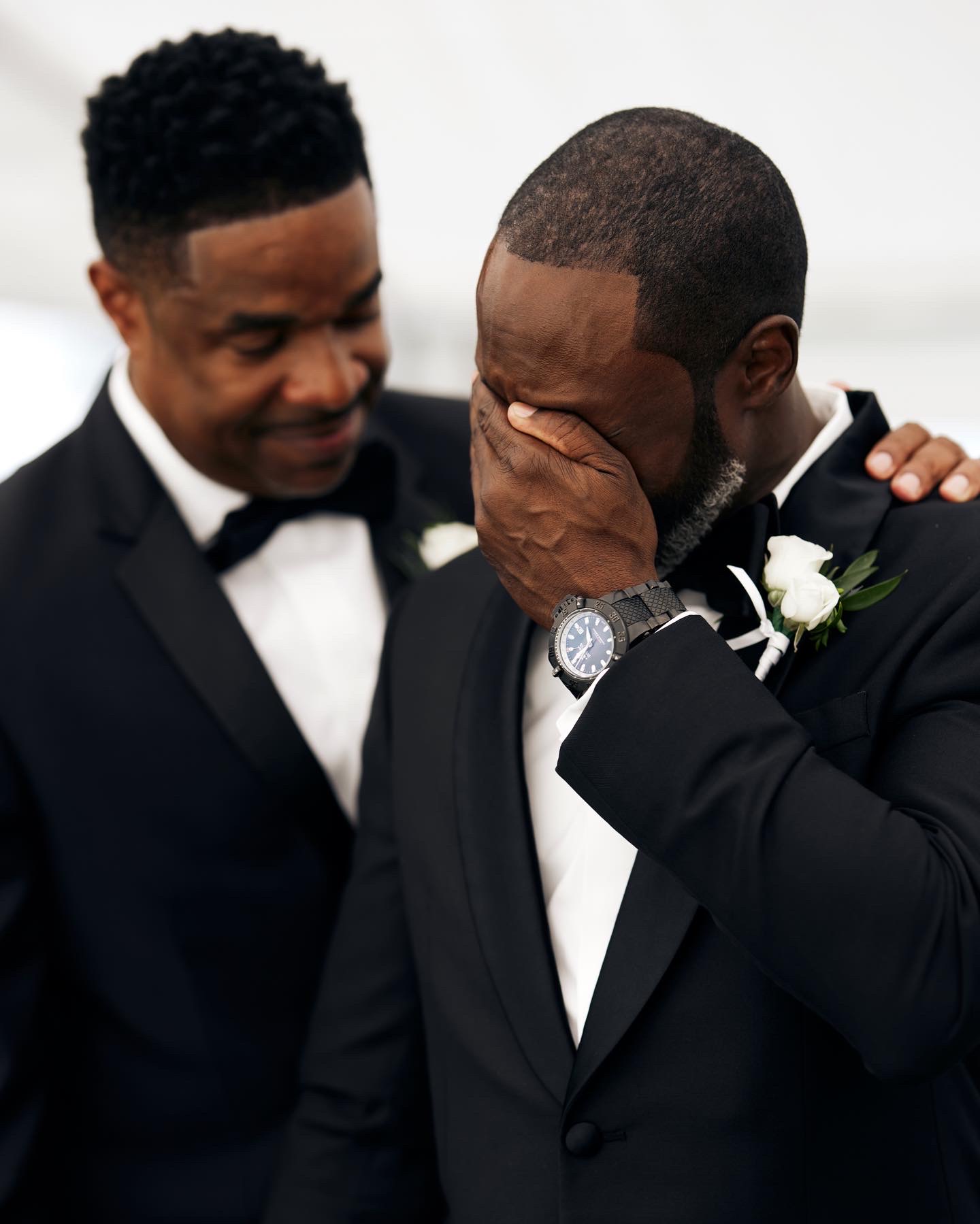 Groom emotional tears with best man during ceremony