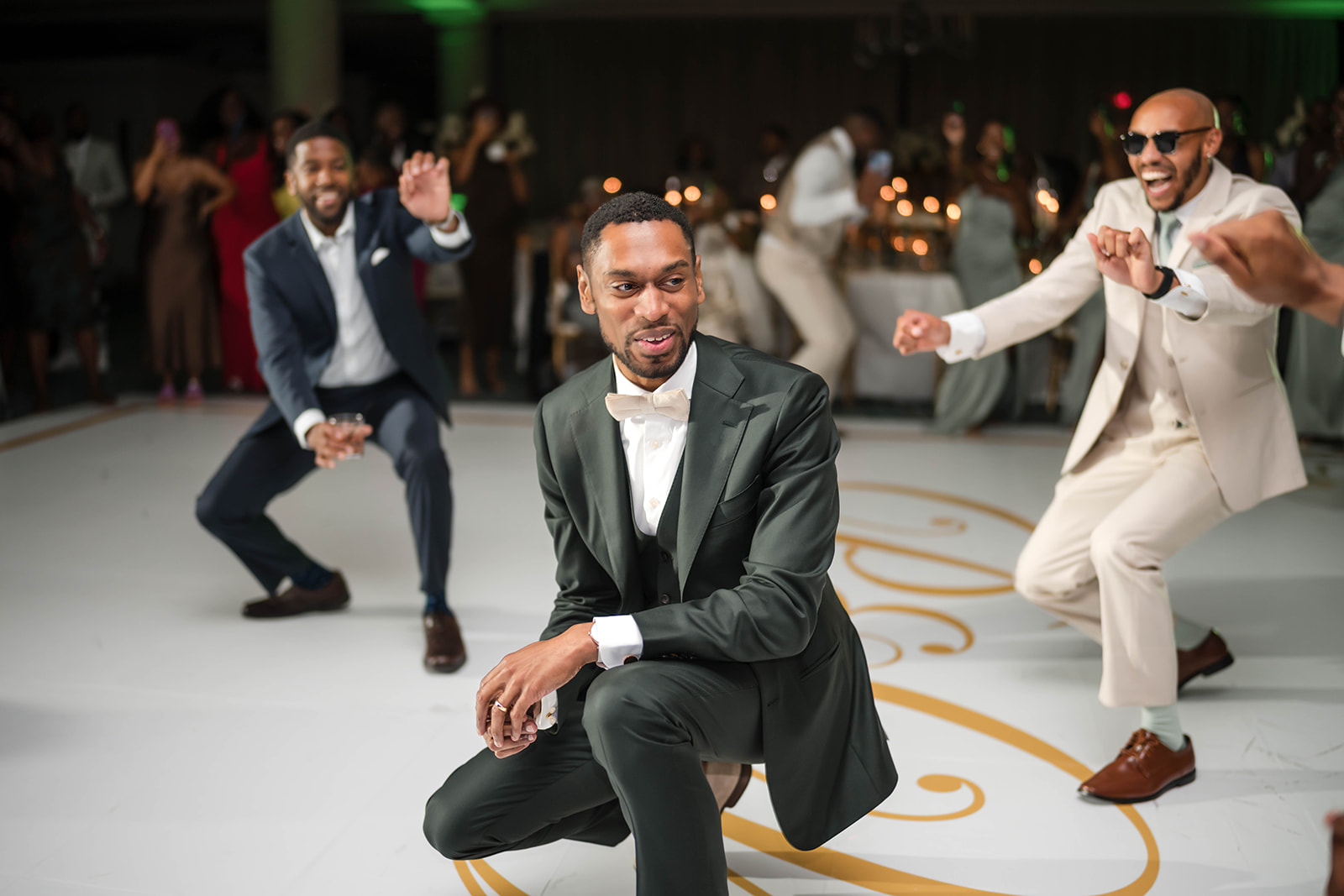 Groom and groomsmen dancing on reception dance floor celebration