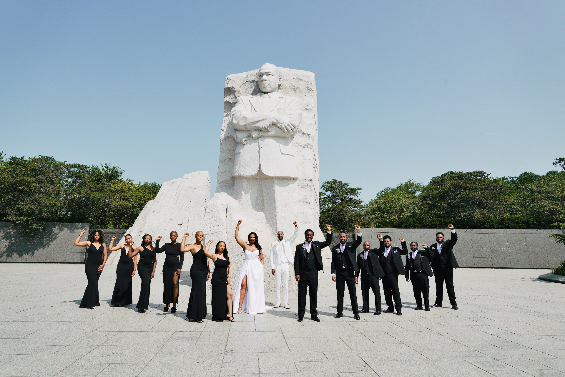 Wedding party at MLK Memorial with fists raised