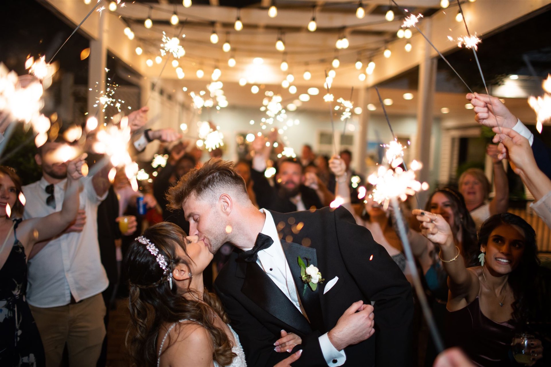 Sparkler exit couple kiss